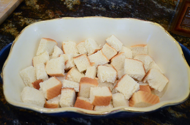 A layer of bread cubes in a casserole dish.