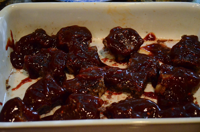 The ribs are topped with the sauce once the cooking liquid is poured off.