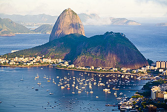 High-angle view of Sugarloaf Mountain and Botafogo Bay at sunset, Rio de Janeiro, Brazil. Sugarloaf is one of the major identifying landmarks of Rio de Janeiro