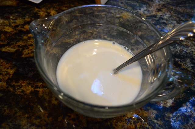Milk, egg whites, vanilla, and almond extract in a measuring cup.