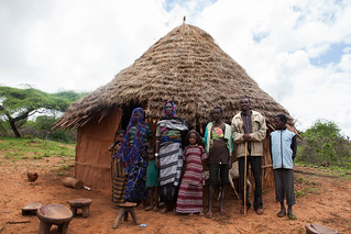A pastoralist family in Borana poses infront of their house