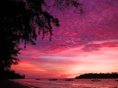 sunset silhouette boats cambodia