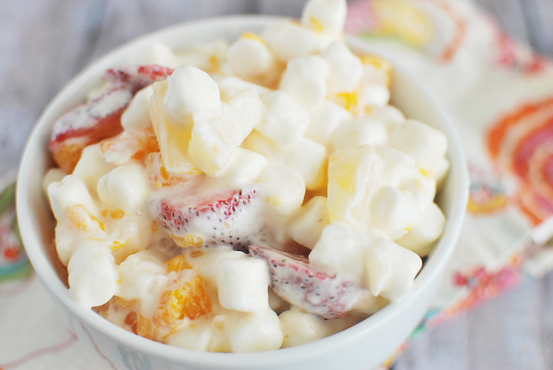 Marshmallow fruit salad with strawberries, pineapple, and mandarin oranges in a white bowl 