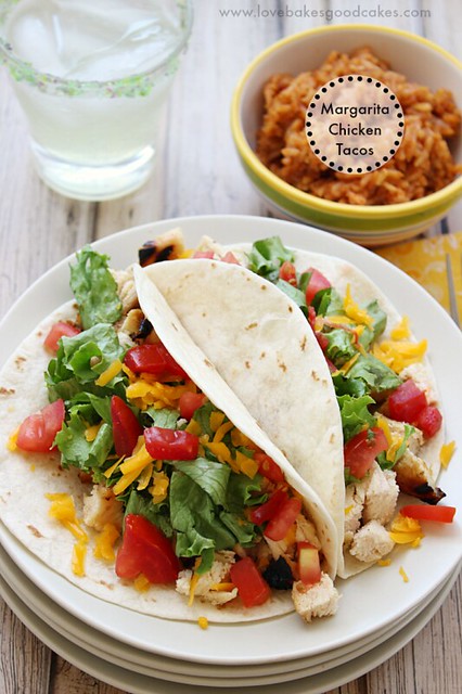 Margarita Chicken Tacos open on a white plate with mexican rice and a drink.
