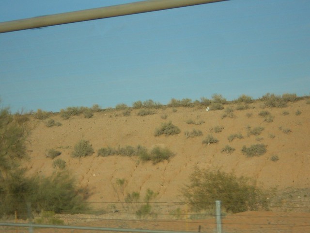 A keen eye will reveal that this shot is through a rapidly passed fence, showing a mostly barren hill. 