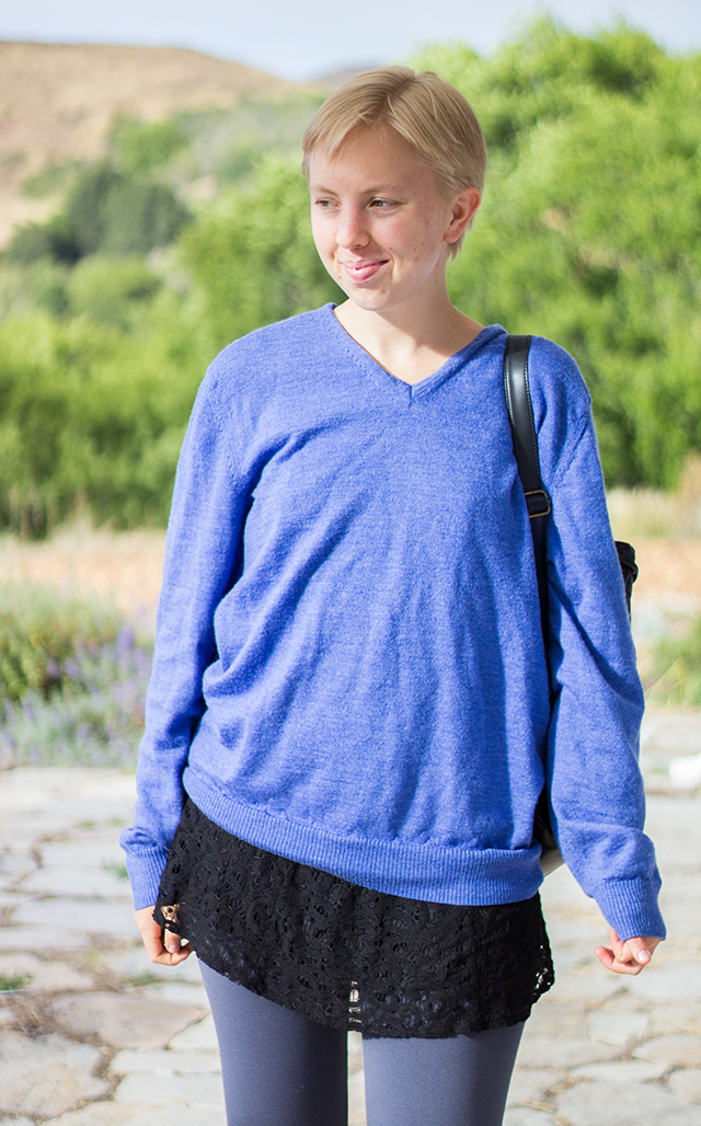 schoolgirl outfit: blue wool sweater, black lace mini dress, grey leggings