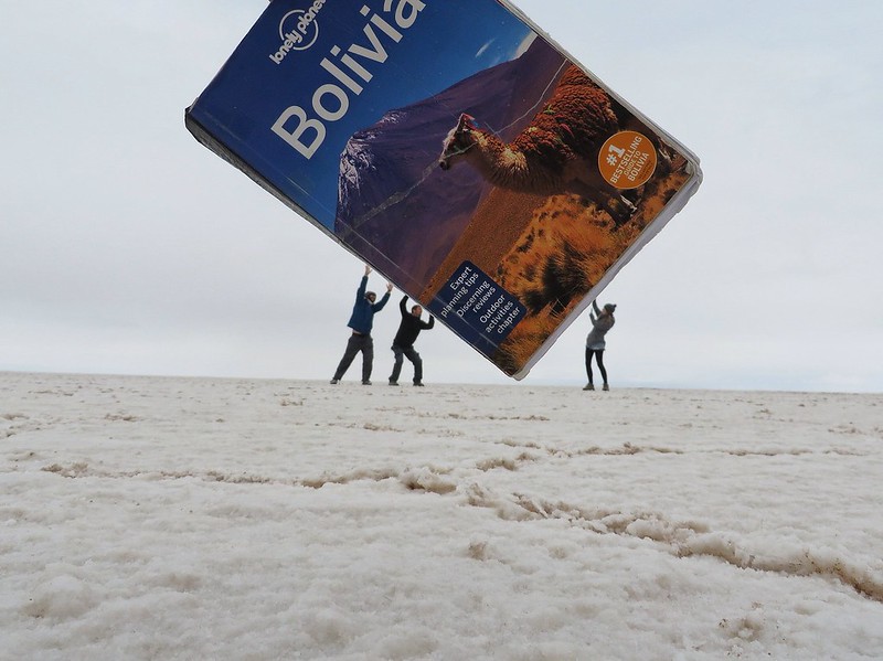 Carrying Lonely Planet Bolivia on the salt flats