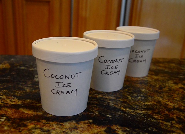 Three containers with "Coconut Ice Cream" written on the side with a sharpie.