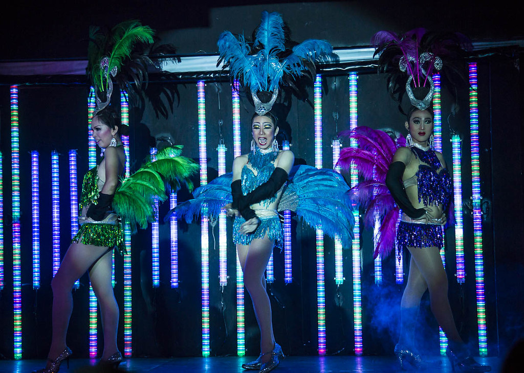 Ladyboys in colorful costumes performing on stage