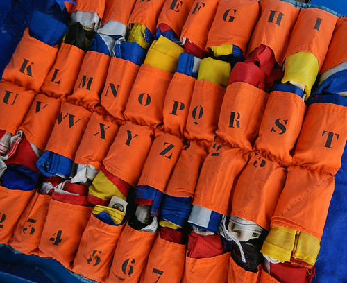 ship's signal flags in an orange case