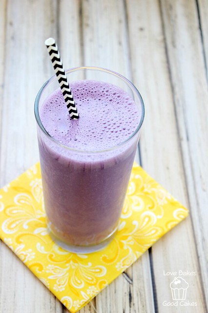 Purple Cow Shake in a glass with a straw.