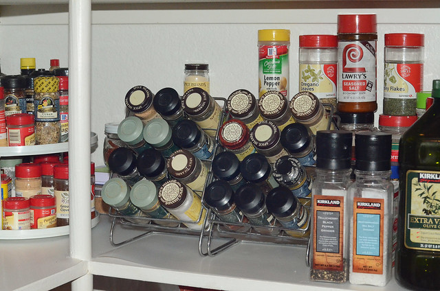 Two spice racks in a pantry.