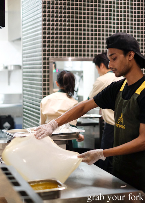 Tossing and stretching roti dough at Pappa Rich, Broadway