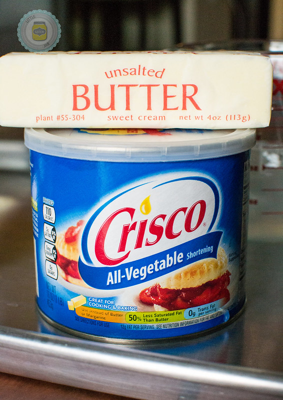 Container of Crisco and a stick of butter on a sheet pan