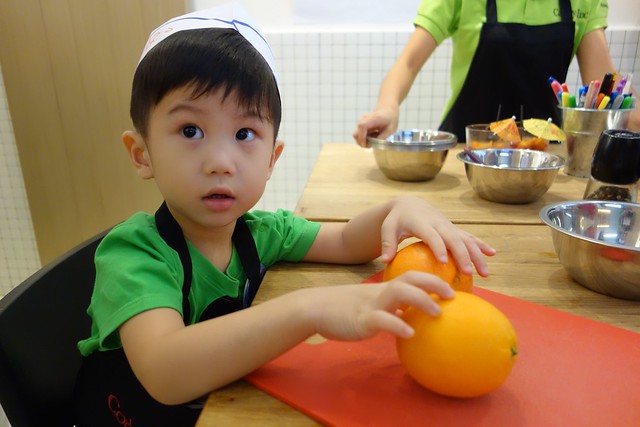 This handsome kid is caught playing with oranges. Heh heh. 