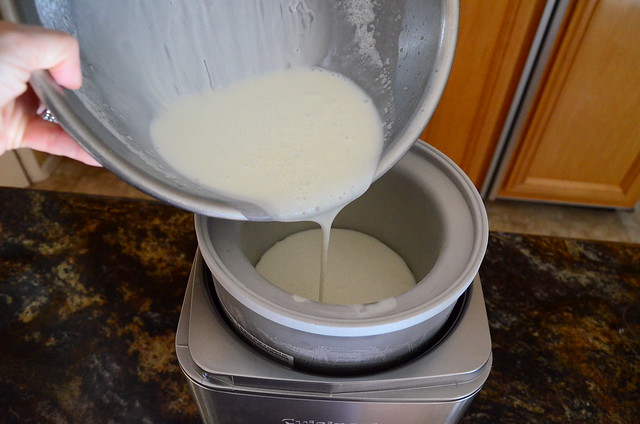 The ice cream mixture being poured into the ice cream machine.