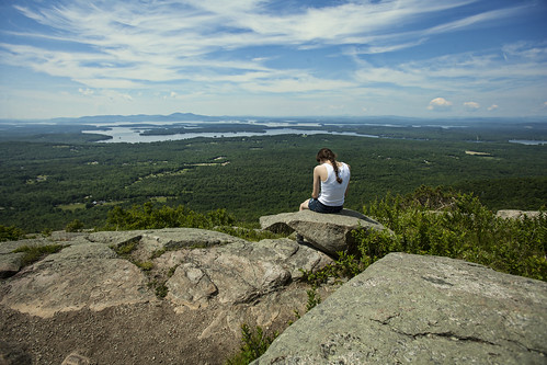 sky people mountains nature look clouds person high rocks view think newhampshire ponder gaze height lakewinnipesaukee