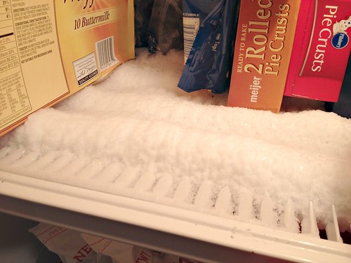 What causes frost to build up in a freezer?