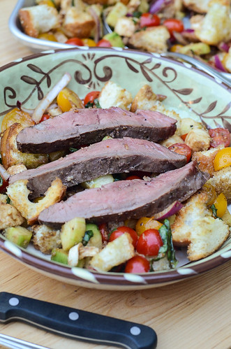 The strips of bison flank steak are placed on top of the toasted bread and veggies.