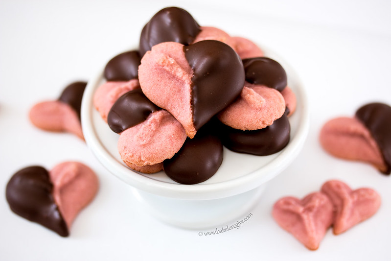 Strawberry jam gives the classic spritz cookie a kiss of natural strawberry flavor while a quick dip in rich dark chocolate makes these cookies just perfect for Valentine's Day.