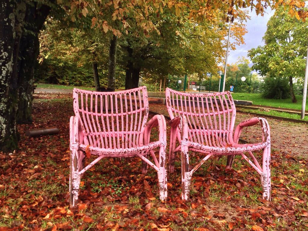 Pink chairs rotting in the autumn weather