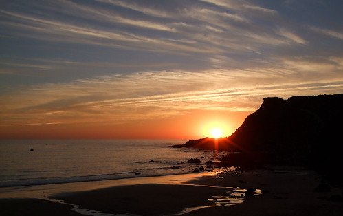 sunset beach portugal rock arrifana