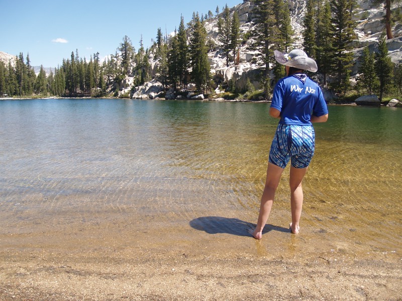 Vicki wading into the ice cold water of Lake 9418 (east of Miller Lake)