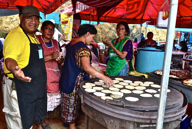 cooking tortillas in guatemala by a local street food vendor
