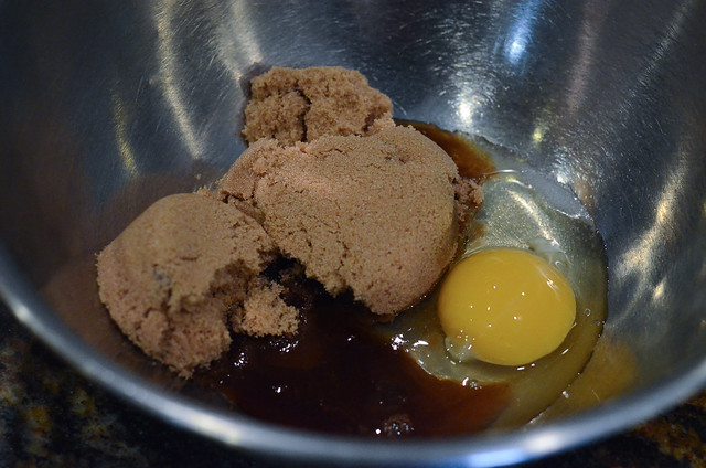 Brown sugar, eggs, and vanilla in a mixing bowl.