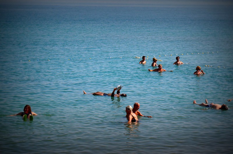 Reading a magazine while floating in the Dead Sea, Israel.