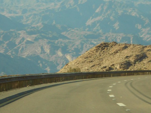 Foreground (a sharp curve in the road); middleground (outcropping of a mountain); background (distant, incomprehensible, overpowering mountain).