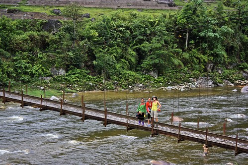 Lina and two guides on a narrow bridge