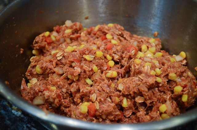 A close up of a metal bowl filled with meatloaf mixture.