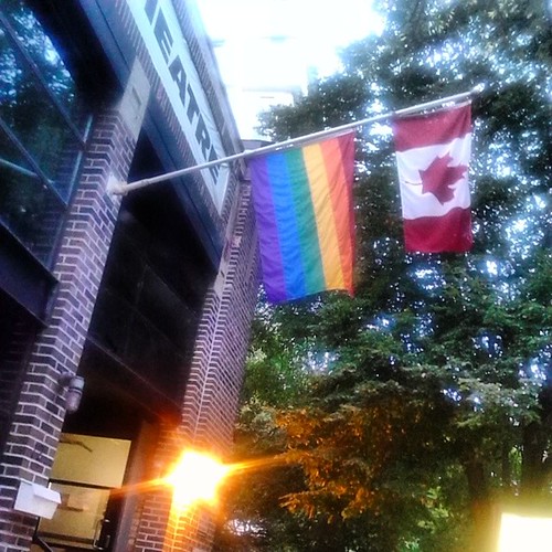 The rainbow flag and the flag of Canada, outside of Buddies in Bad Times #toronto #Torontophotos #theatre #buddiesinbadtimes #churchandwellesley #flags #rainbow #canada