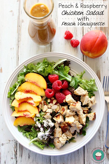 Peach & Raspberry Chicken Salad with Peach Vinaigrette in a bowl with a fork.