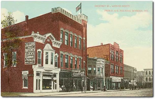 people usa signs man color men history boys kids buildings advertising children awning clothing general indiana streetscene bicycles shops pedestrians storefronts grocery seymour banks businesses departmentstores dentists jeweler jacksoncounty hoosierrecollections