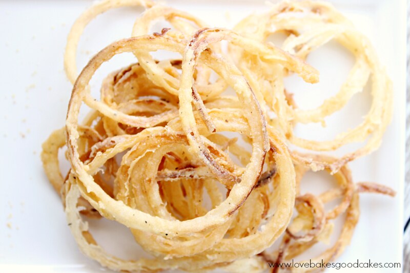 Onion Rings - Thin and Crispy on a plate close up.