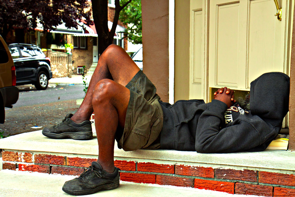 Man-in-hoodie-sleeping-in-front-of-door-on-9-8-14--Passyunk-Square