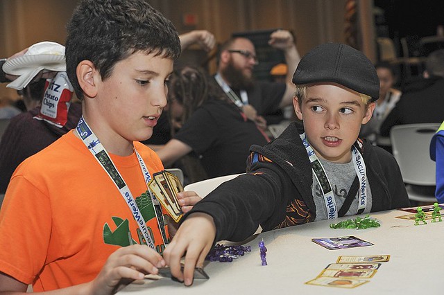 Jeffrey Schneider, 11, from Oak Hill, Virginia (left) and Evan Last, 10, of  New Market, Maryland (right), played Munchkin during "Spawncamp" at BSides 2016.
