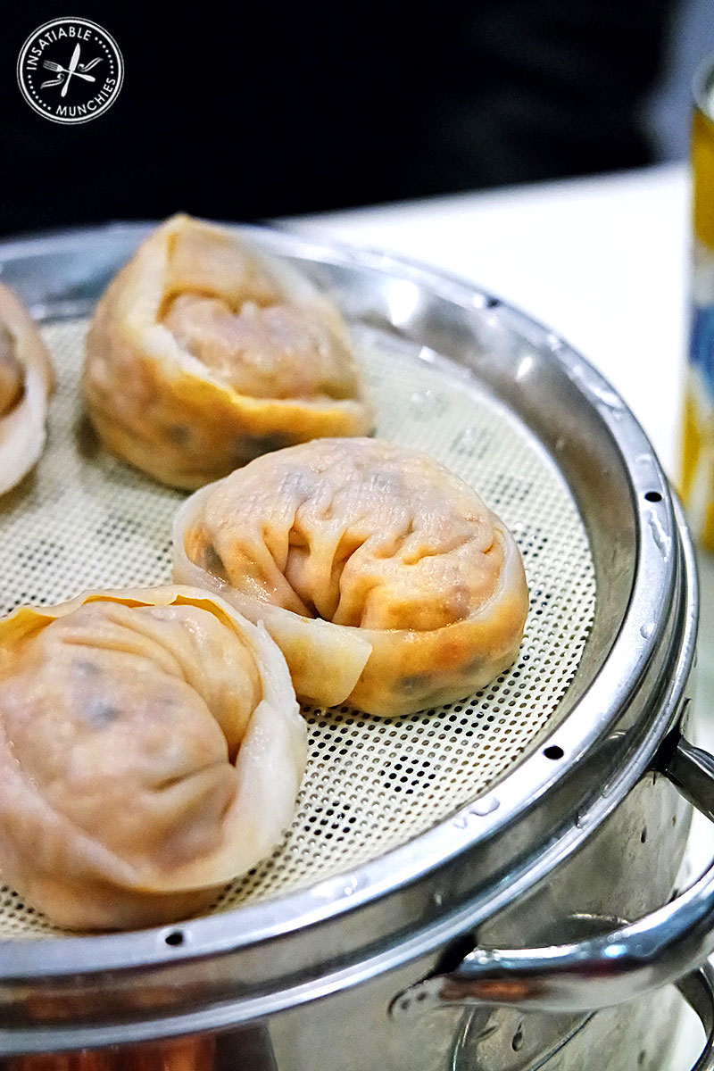 Kimchi Mandoo - Korean style bun dumplings are stuffed with a pork and kimchi filling, and steamed in a metal steamer.