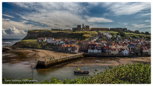 houses sky church abbey clouds boat harbour cliffs whitby