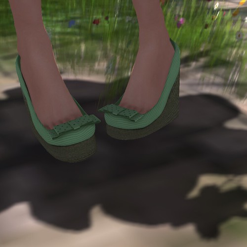 Image Description: Close up of feet wearing pale green espadrilles in shadow.