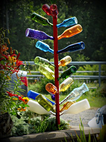 flowers tree glass metal yard bottles colourful laplante theglassmenagerie