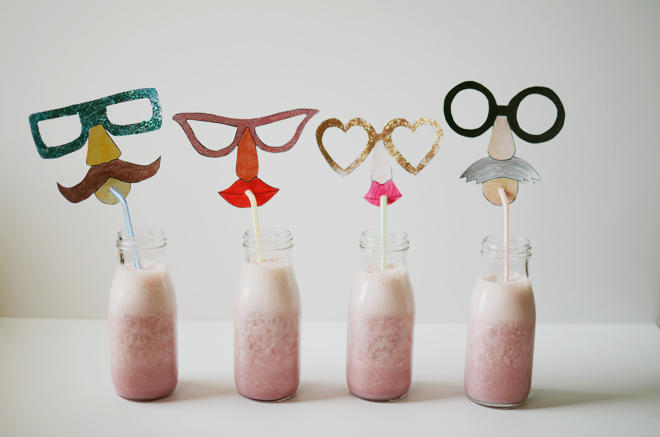 strawberry milkshakes with funny face straw toppers
