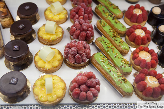 Cakes from left to right: Mi-Cut, Yuzu Tart, Raspberry Tarts, Pistachio eclairs, Lemon meringue and raspberry tarts