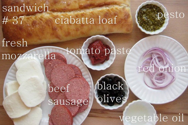 52 sandwiches no. 37: beef sausage, mozzarella, black olives, + pesto