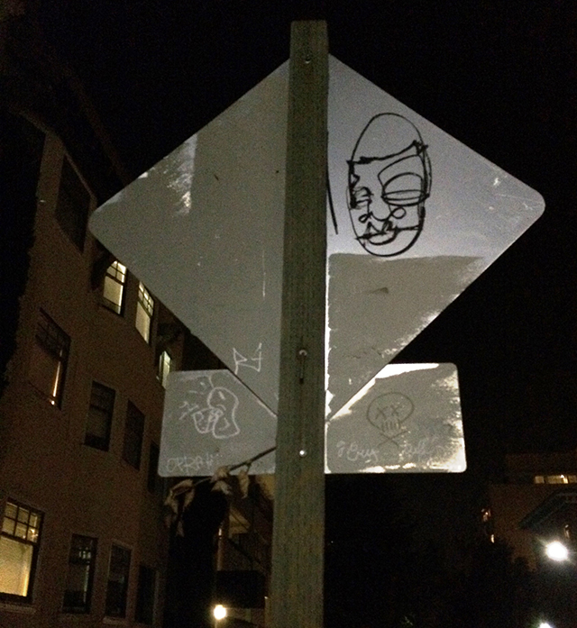 graffiti portrait on the back of the traffic sign, Oakland 9/13/2014