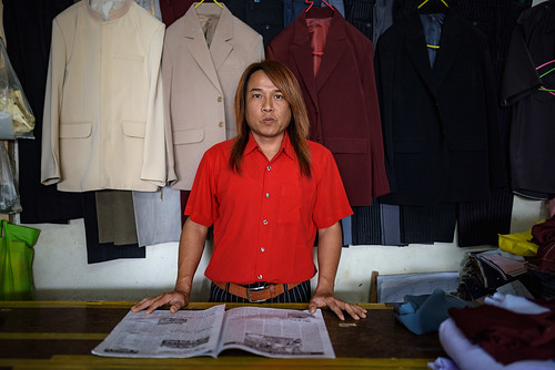 lashio myanmarburma asia nikon sigma d810 portrait red vibrant tailor street streetphotography clothes clothing newspaper candid
