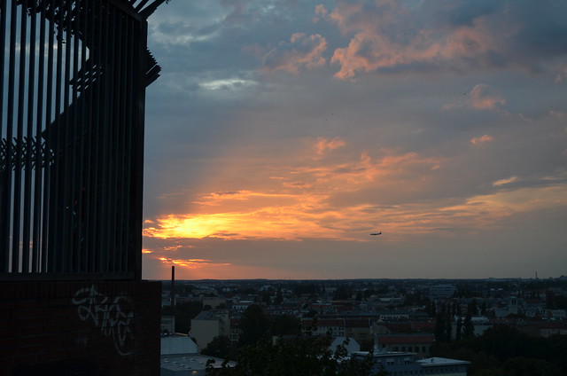 Berlin Park Volkspark Humboldthain plane flying into sunset over city