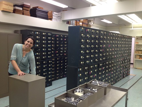 woman moving drawers filled with vials